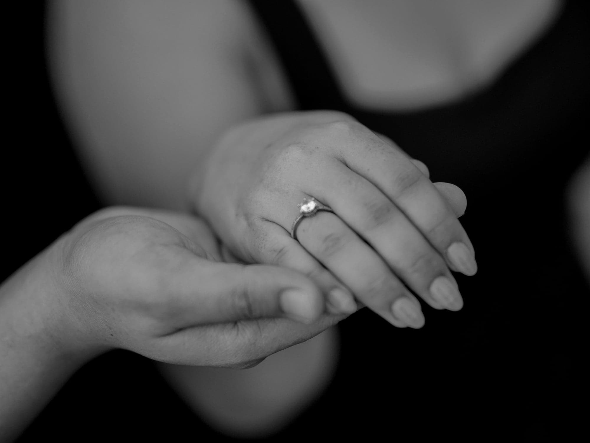 Close-up of Ina's engagement ring as they hold hands